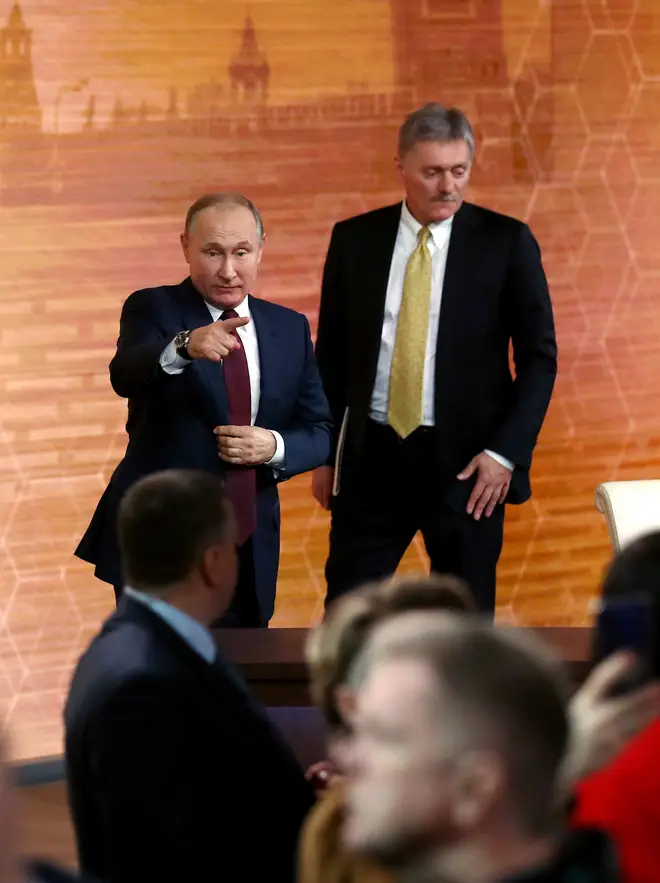 Russia's President Vladimir Putin (L) and his spokesman Dmitry Peskov