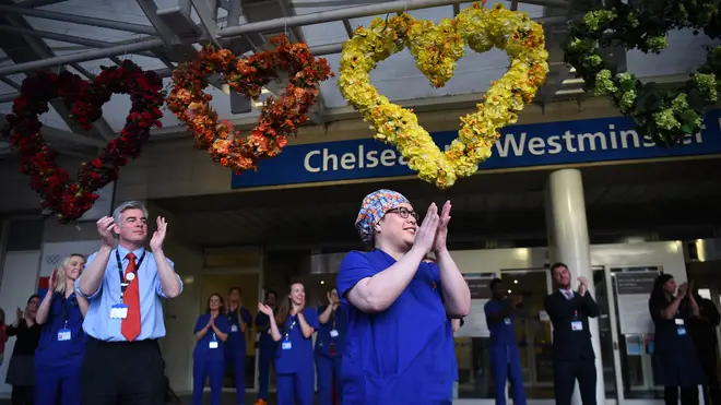 File photo: Medical staff outside the Chelsea and Westminster Hospital, London, join in the applause during Thursday's nationwide Clap for Carers