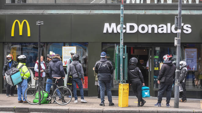 Delivery drivers seen queuing round the corner at a recently reopened McDonald's store in Tooting