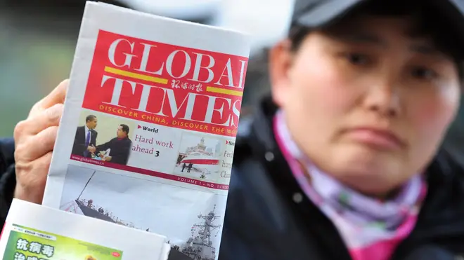 File photo from 2009 showing a news vendor displaying the Global Times on her stand