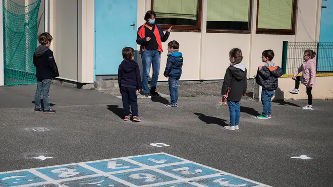 Children socially distance in a playground in France