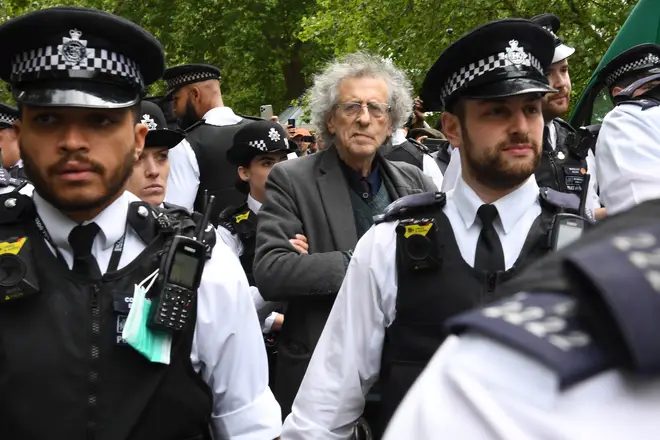 Police lead away Piers Corbyn, brother of former Labour leader Jeremy Corbyn, as protesters gather in breach of lockdown rules in Hyde Park