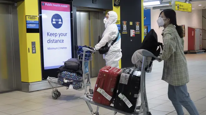 Passengers wearing PPE at Heathrow Airport