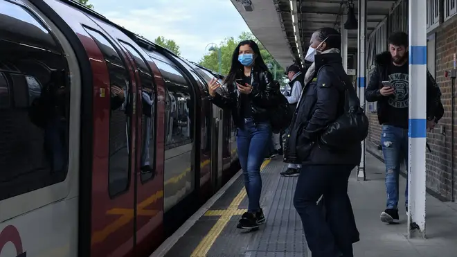 Commuters board Tube trains in protective masks