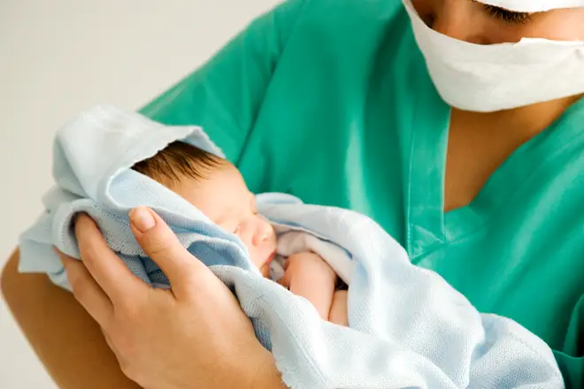 Midwives now have to wear full protective gear, including facemasks