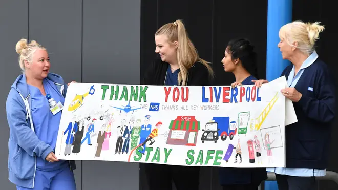 NHS workers hold up a sign thanking Liverpool ahead of a national "clap for carers"