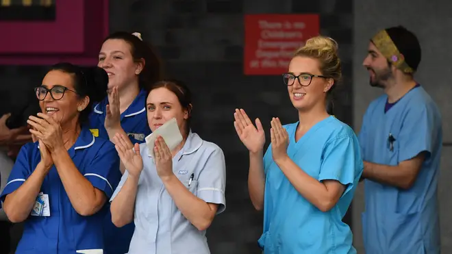 NHS workers participate in a national "clap for carers"