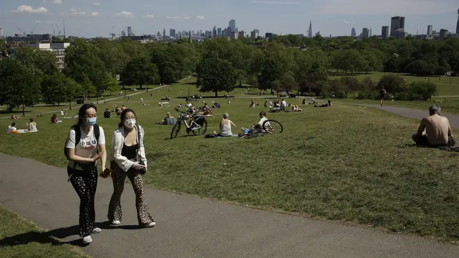 People relax on Primrose Hill on Wednesday