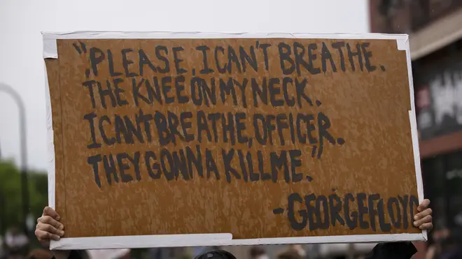 Protesters carried signs of Mr Floyd's last words