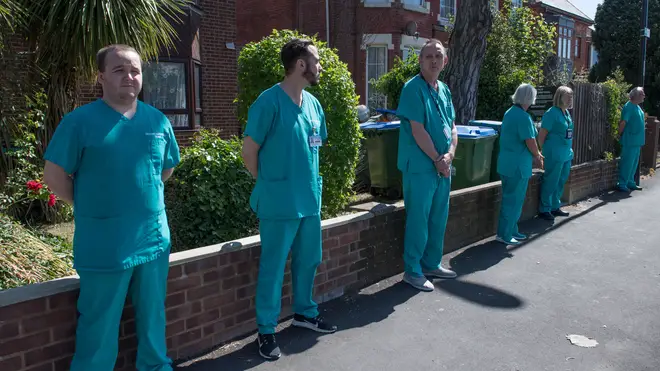 Hospital staff line the streets