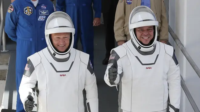 Nasa astronauts Douglas Hurley, left, and Robert Behnken walk out of the Neil A. Armstrong Operations and Checkout Building