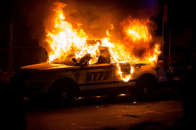 An NYPD vehicle burns as violence intensifys