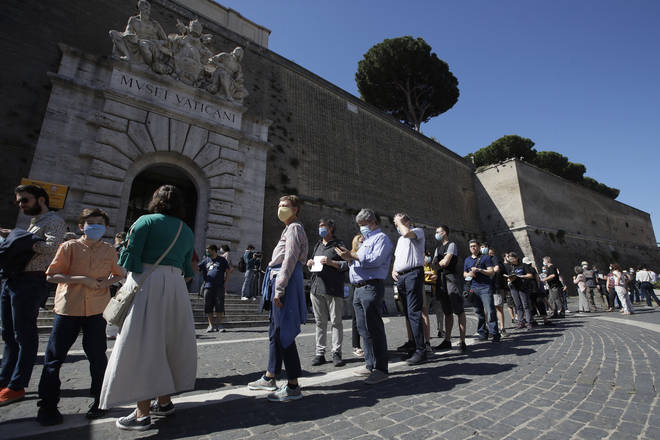 Visitors line up to enter the Vatican Museums on their reopening date