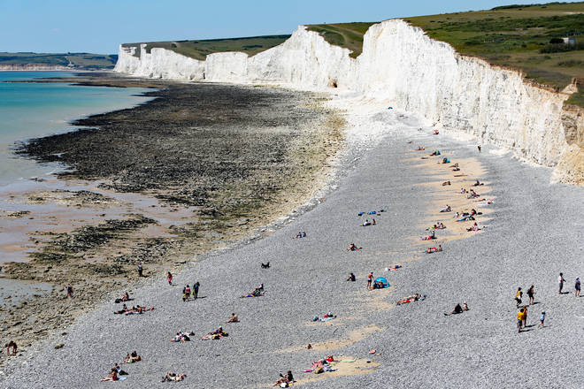 Sunbathers appearing to abide by social distancing measures at Birling Gap, East Sussex