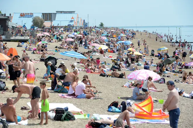 People enjoying the good weather on the beach at Southend-on-Sea in Essex