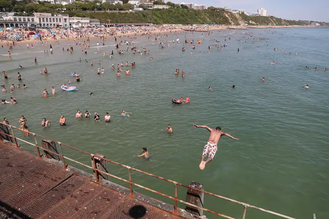 A swimmer jumps into the sea in Bournemouth