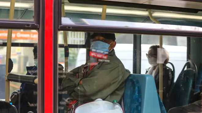 A passenger on a London bus wearing a protective mask as a preventive measure during COVID-19 outbreak