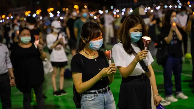 Tens of thousands gathered in Hong Kong for the vigil, defying a ban