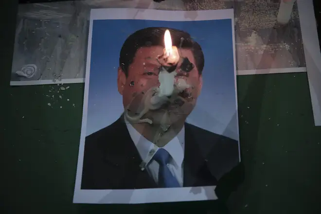 One candle was seen burning on a picture of Chinese President Xi Jinping
