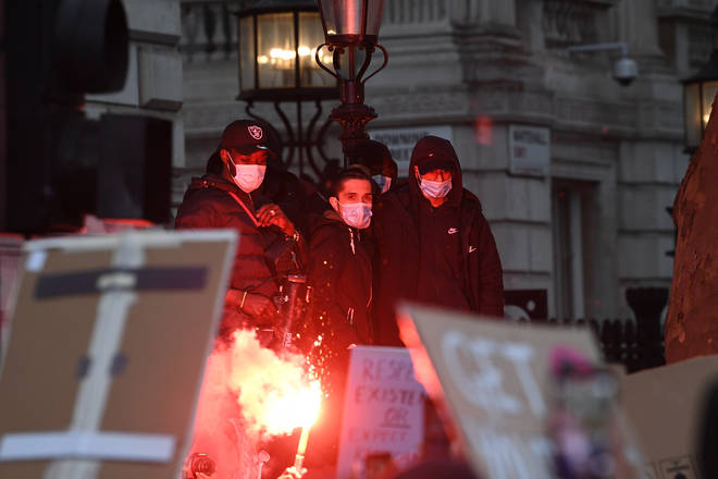 Protesters lit flares as the crowd gathered on Whitehall