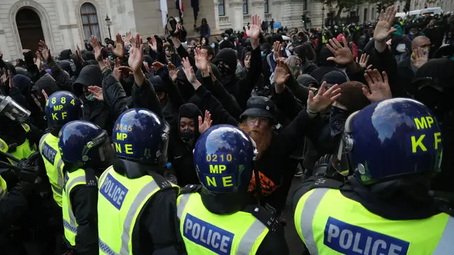 Protesters pictured against a line of police officers