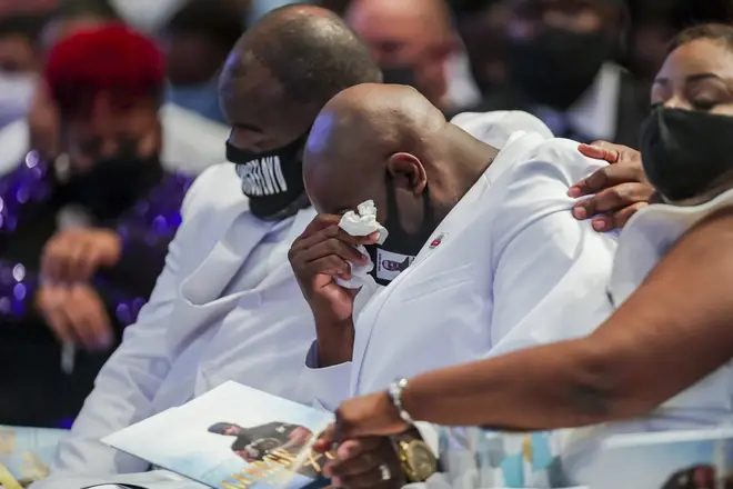 Rodney Floyd puts his arm around his brother Philonise Floyd as they listen to the song "Oh, How Precious" sung during the funeral for their brother, George
