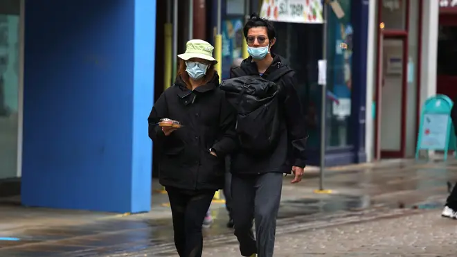 Members of the public wear masks on Market Street, Manchester