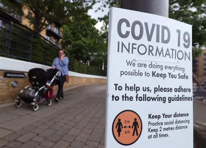 Signage related to social distancing and Covid-19 on display in London