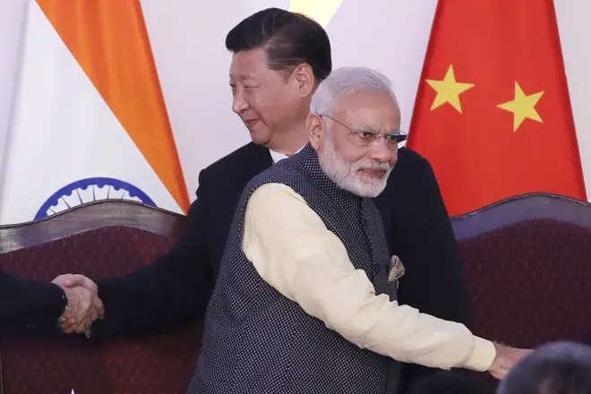 File photo: Indian Prime Minister Narendra Modi, front and Chinese President Xi Jinping shake hands with leaders at the BRICS summit in Goa