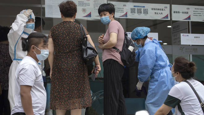 Beijing residents arrive at a health centre for COVID-19 testing