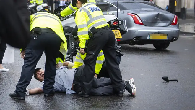 A protester leapt in front of the Prime Minister's official car