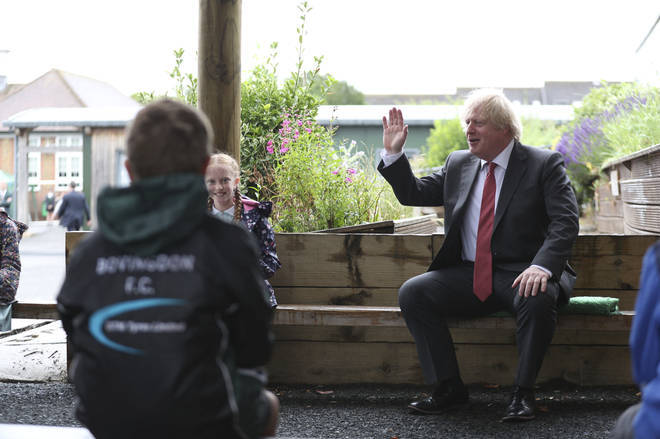 Boris Johnson joins a socially distanced lesson during a visit to Bovingdon Primary School