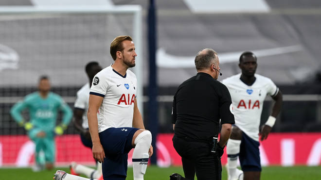 Tottenham Hotspur's English striker Harry Kane (L) 'takes a knee' in support of the Black Lives Matter movement