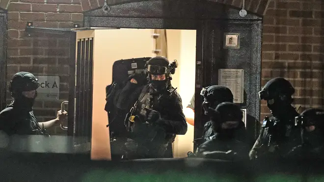 Counter terrorism officers were seen at a nearby address