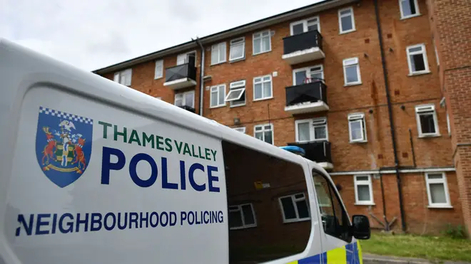 A police van is pictured outside a block of flats where the suspect of a multiple stabbing incident the previous day is believed to have lived