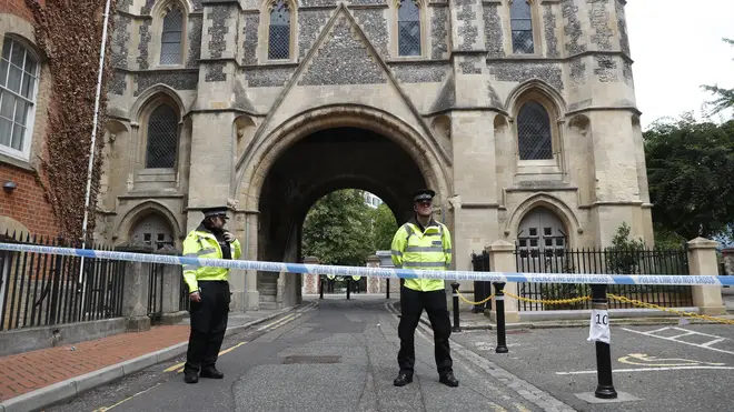 Police stand guard at the Abbey gateway of Forbury Gardens, a day after a multiple stabbing attack in the gardens in Reading