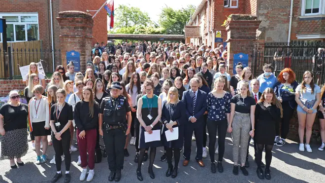Colleagues and pupils of teacher James Furlong take part in a period of silence at the Holt School, Wokingham