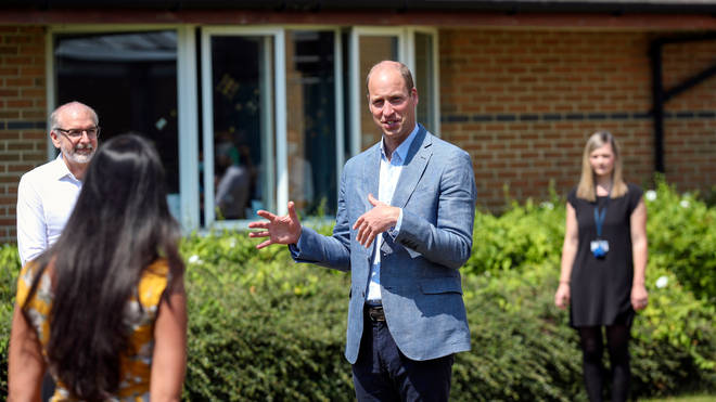 The Duke of Cambridge talks to staff at the Oxford Vaccine Group's facility at the Churchill Hospital