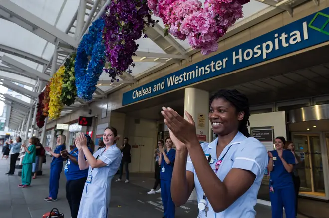 Doctors and nurses clap their hands outside Chelsea and Westminster Hospital during the weekly 'Clap for our Carers'