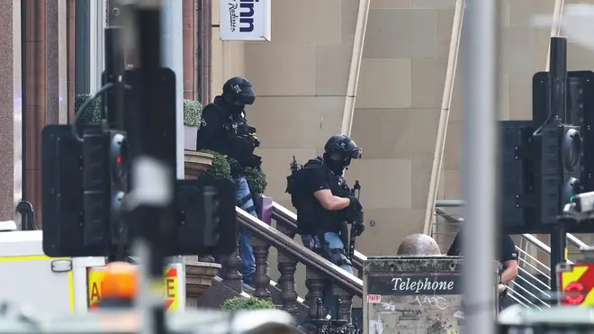 Armed police officers leave the Park Inn hotel in West George Street, Glasgow