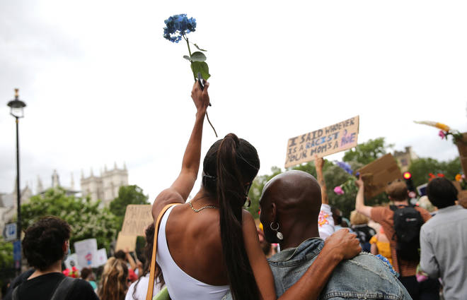 Some of the demonstrators held flowers while marching through London