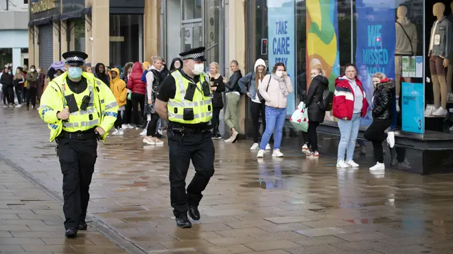Police patrol in Edinburgh as shoppers queue