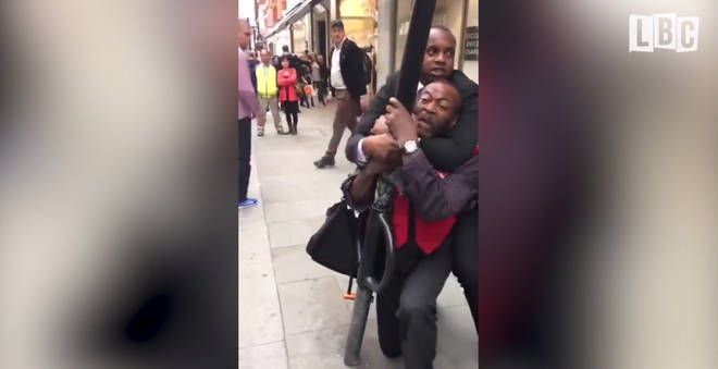 M&S security guard chokes a Big Issue seller.