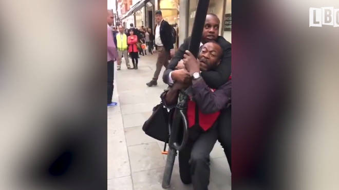 M&S security guard chokes a Big Issue seller.