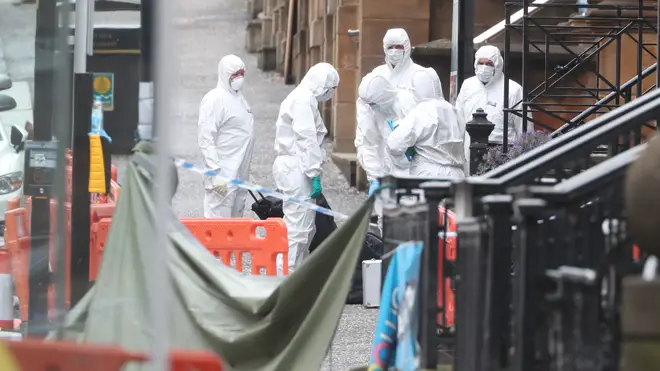 Forensic investigators at the scene in Glasgow