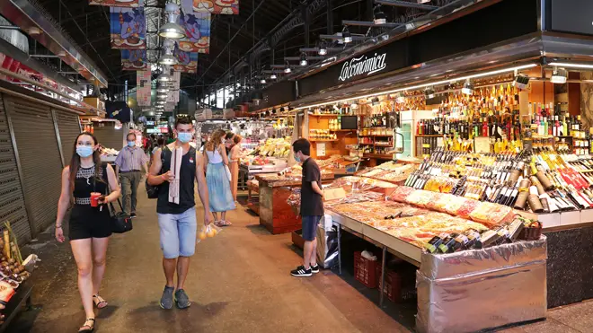 Shoppers in a market in Spain during the coronavirus crisis - file image