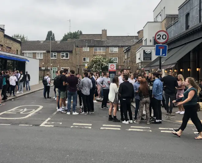 A large crowd outside a pub in London