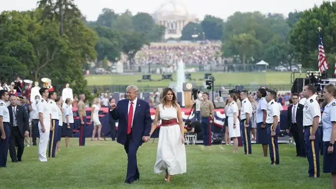 Donald Trump and Melania walk back to the White House after the 4th July speech