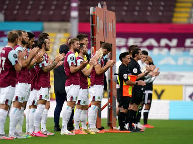 Players and match officials take part in minutes applause for NHS staff and key workers prior to the Premier League match at Turf Moor, Burnley