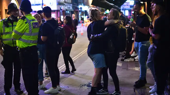 People enjoy a drink in Soho last night